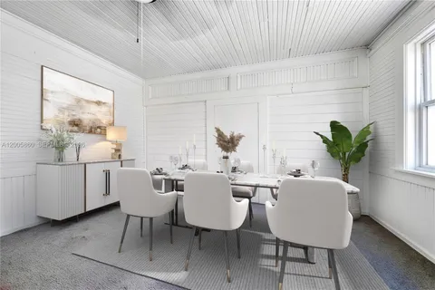 a view of a dining room with furniture and window