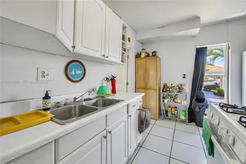 a kitchen with a sink and a refrigerator