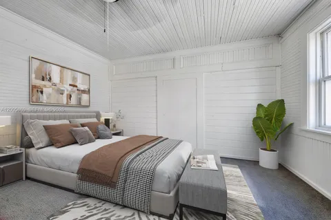 a bedroom with bed and a couch