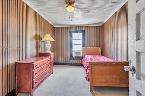a bed room with a bed and a chandelier