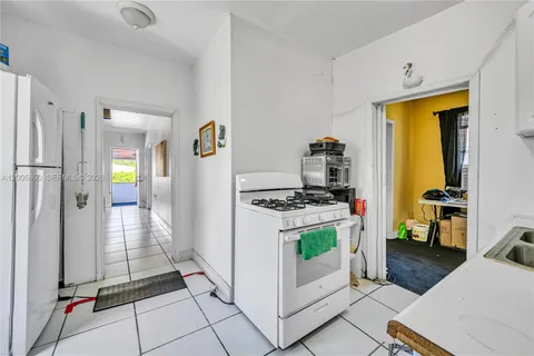 a kitchen with stainless steel appliances granite countertop a refrigerator and a stove