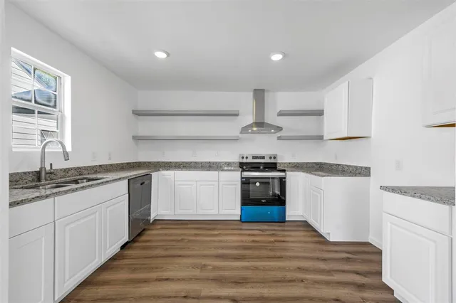 a kitchen with a stove top oven sink and cabinets