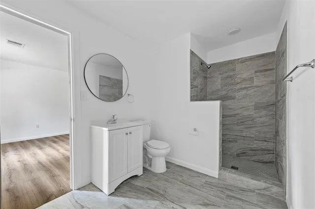 a bathroom with a toilet a sink and garden