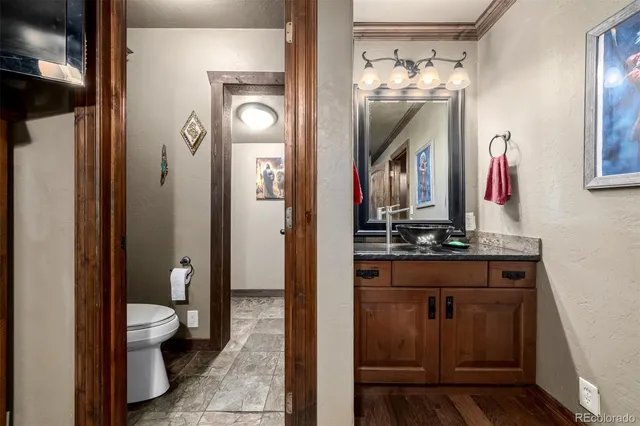a bathroom with a toilet sink and mirror