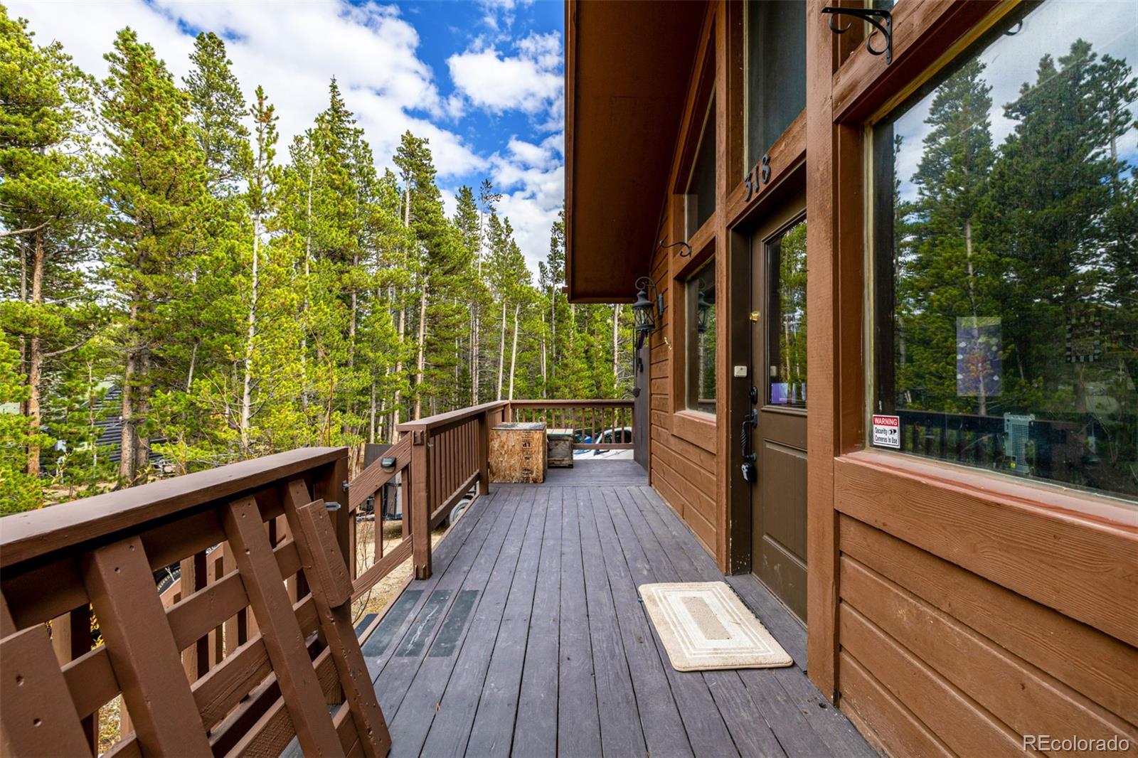 318 Upper Forest Road Idaho Springs, CO 80452 - Photo 19 of 24 a view of balcony with wooden floor and outdoor seating