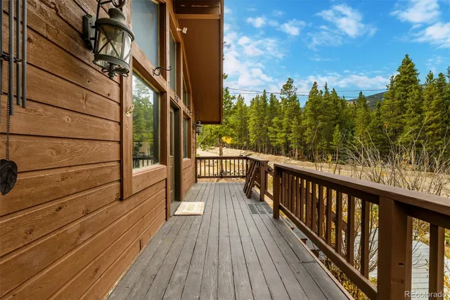 a view of balcony with wooden floor and fence