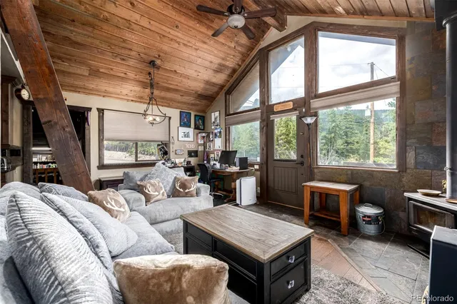 a living room with furniture a flat screen tv and windows
