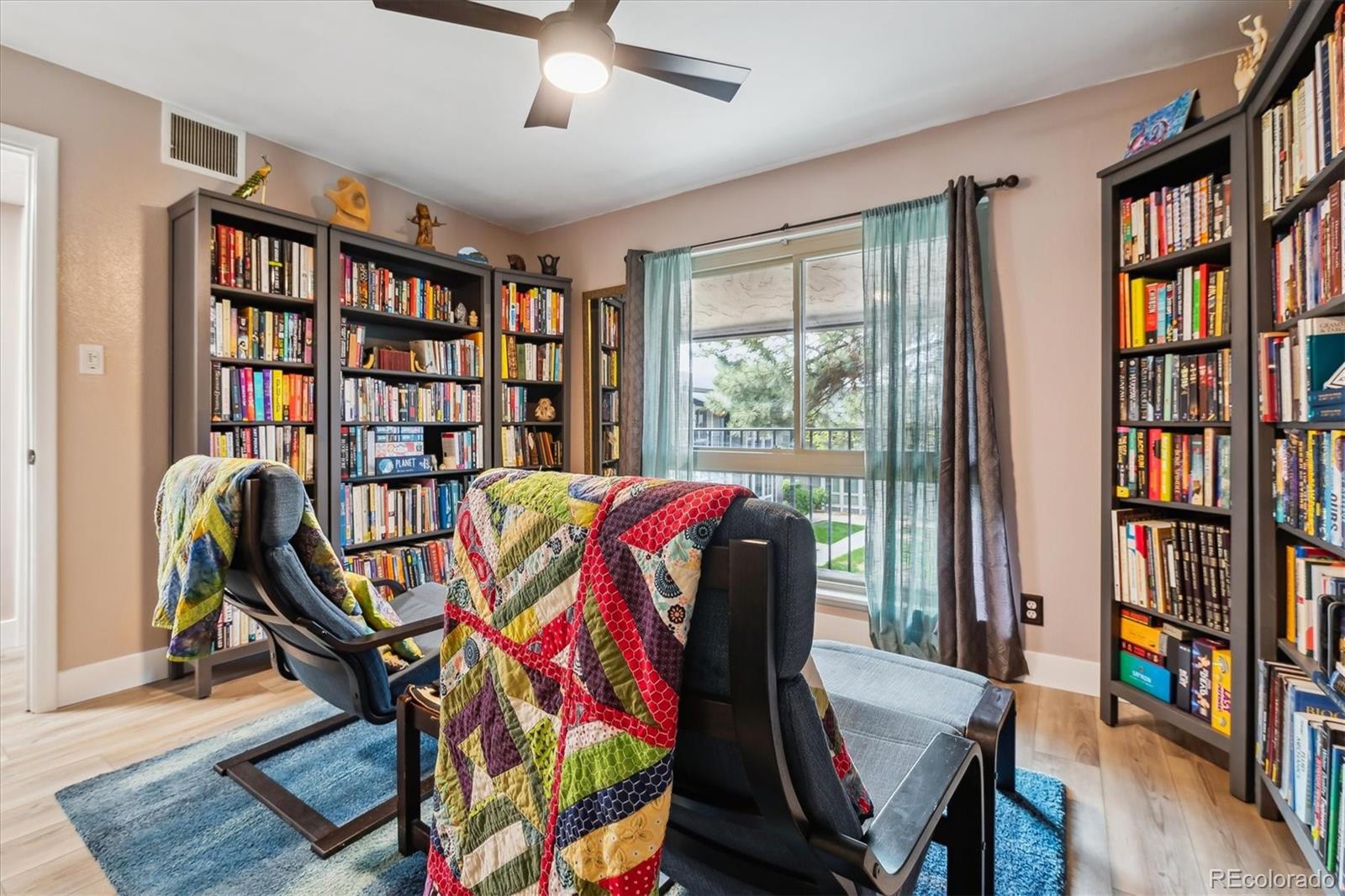 6495 East Happy Canyon Road, Unit 163 Denver, CO 80237 - Photo 12 of 27 a view of a workspace with furniture and a book shelf