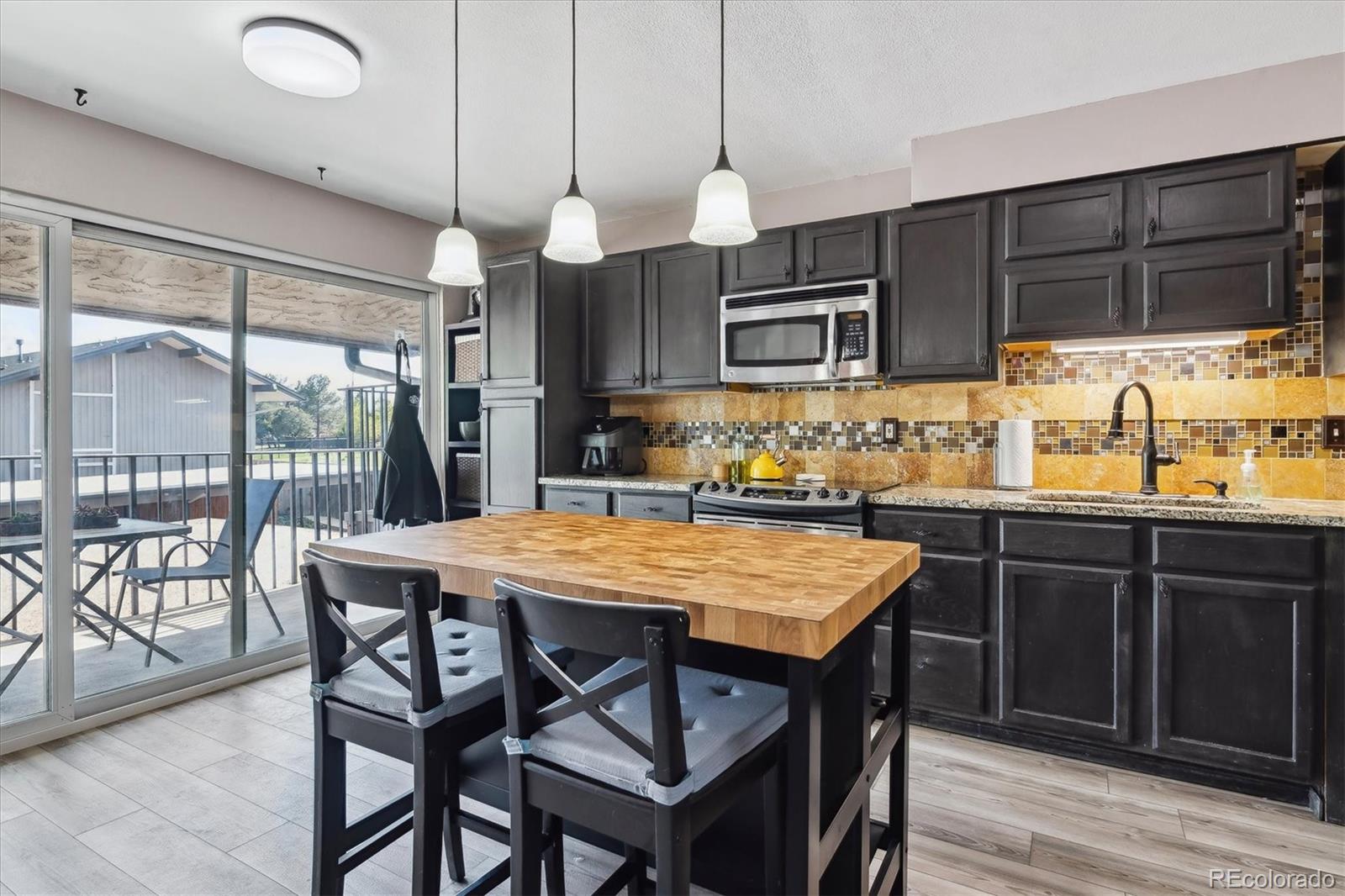 6495 East Happy Canyon Road, Unit 163 Denver, CO 80237 - Photo 14 of 27 a kitchen with a table and chairs in it