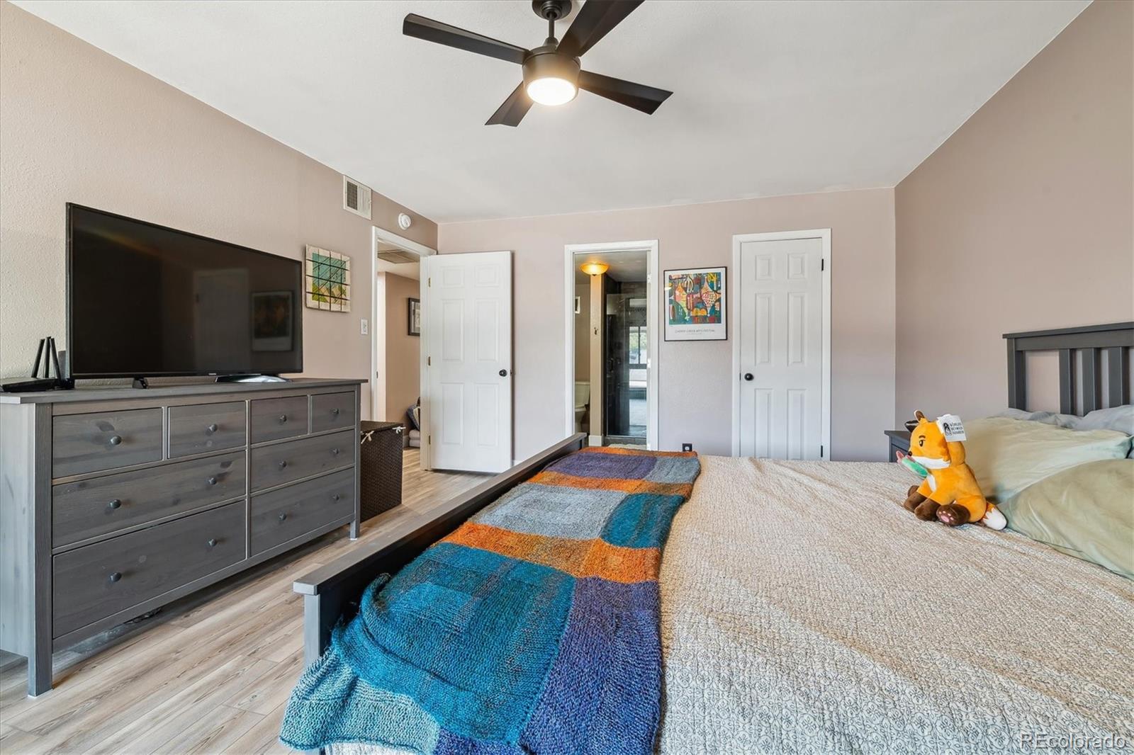 6495 East Happy Canyon Road, Unit 163 Denver, CO 80237 - Photo 17 of 27 a bedroom with a bed and flat screen tv