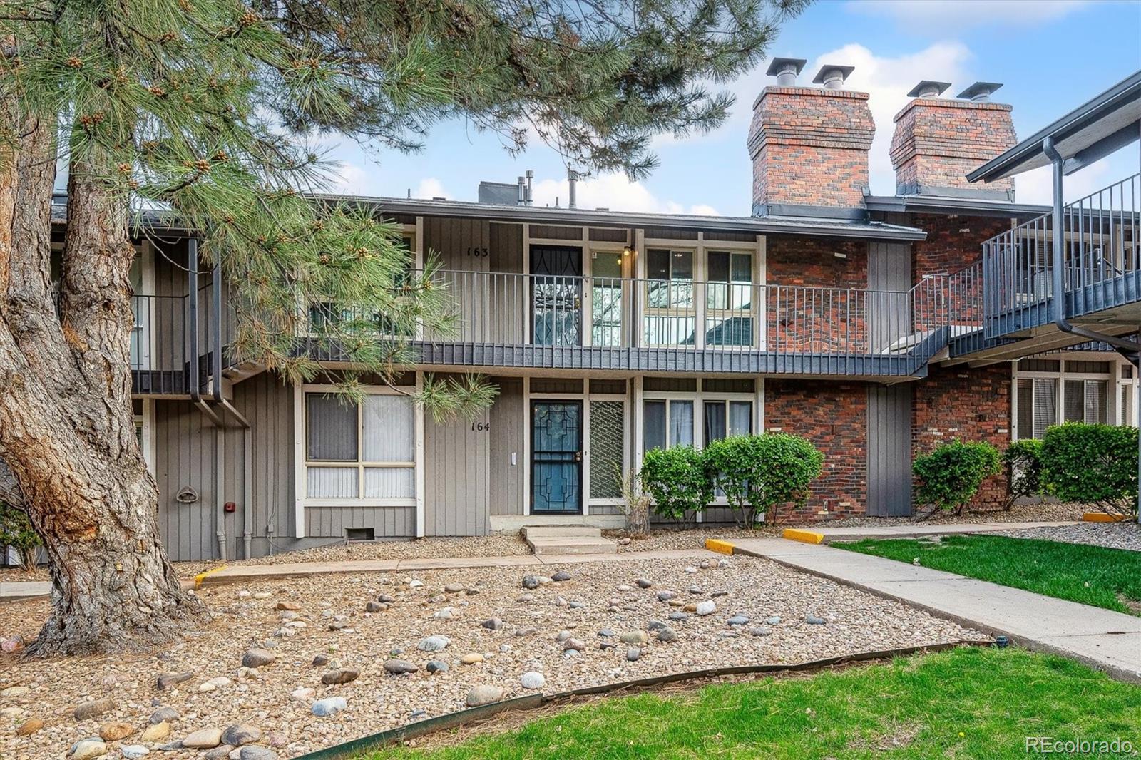 6495 East Happy Canyon Road, Unit 163 Denver, CO 80237 - Photo 22 of 27 a front view of a house with a garden