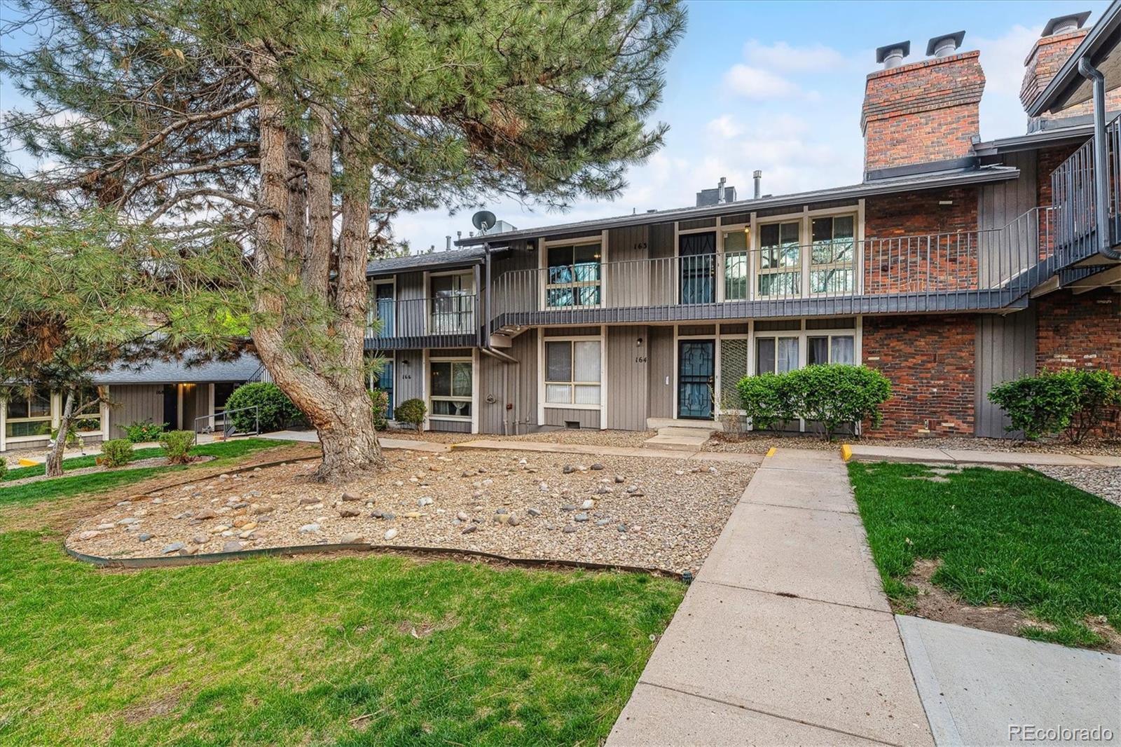 6495 East Happy Canyon Road, Unit 163 Denver, CO 80237 - Photo 23 of 27 a front view of a house with a garden