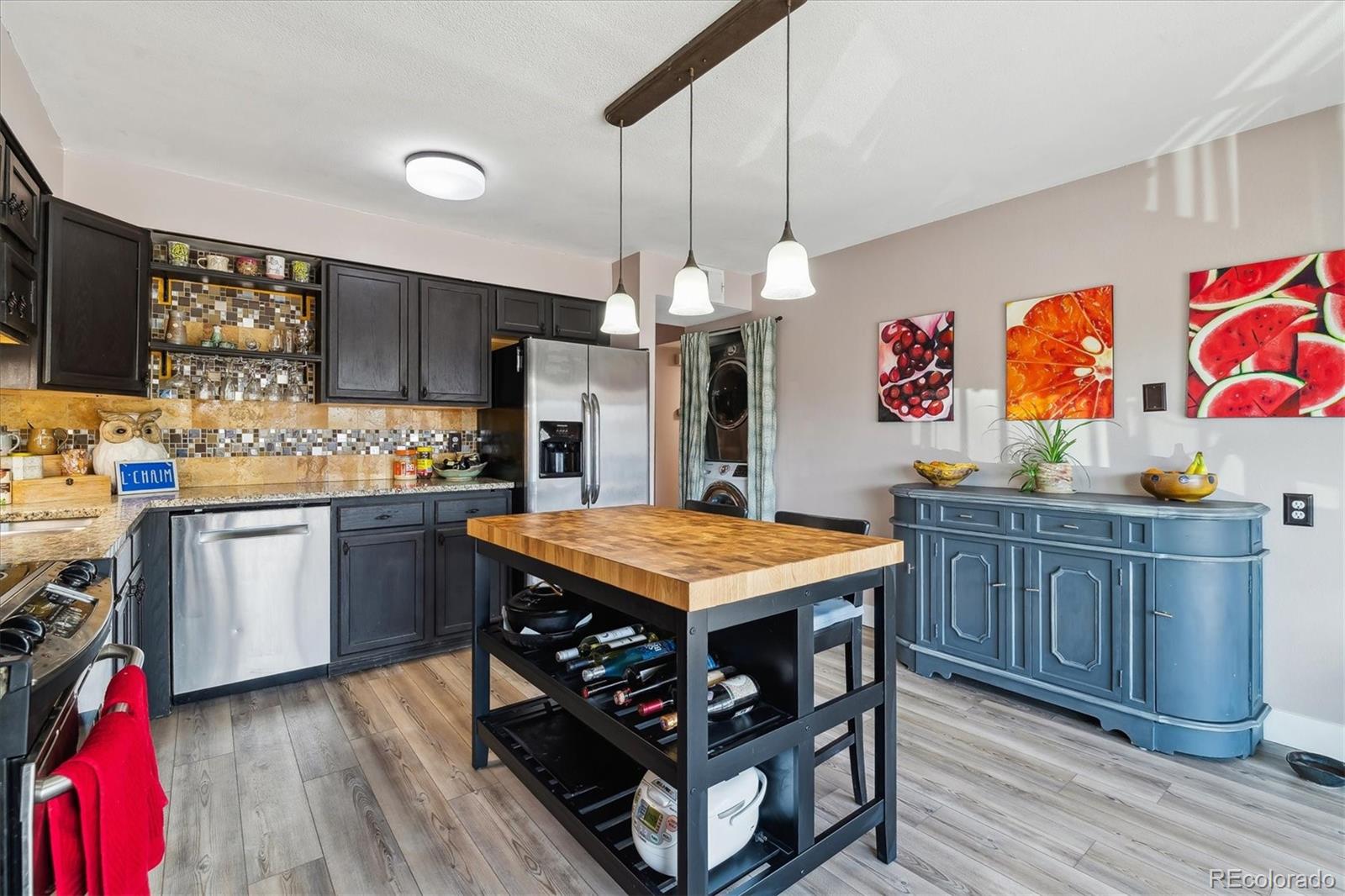 6495 East Happy Canyon Road, Unit 163 Denver, CO 80237 - Photo 3 of 27 a kitchen with stainless steel appliances granite countertop a stove a sink dishwasher and a refrigerator with wooden floor