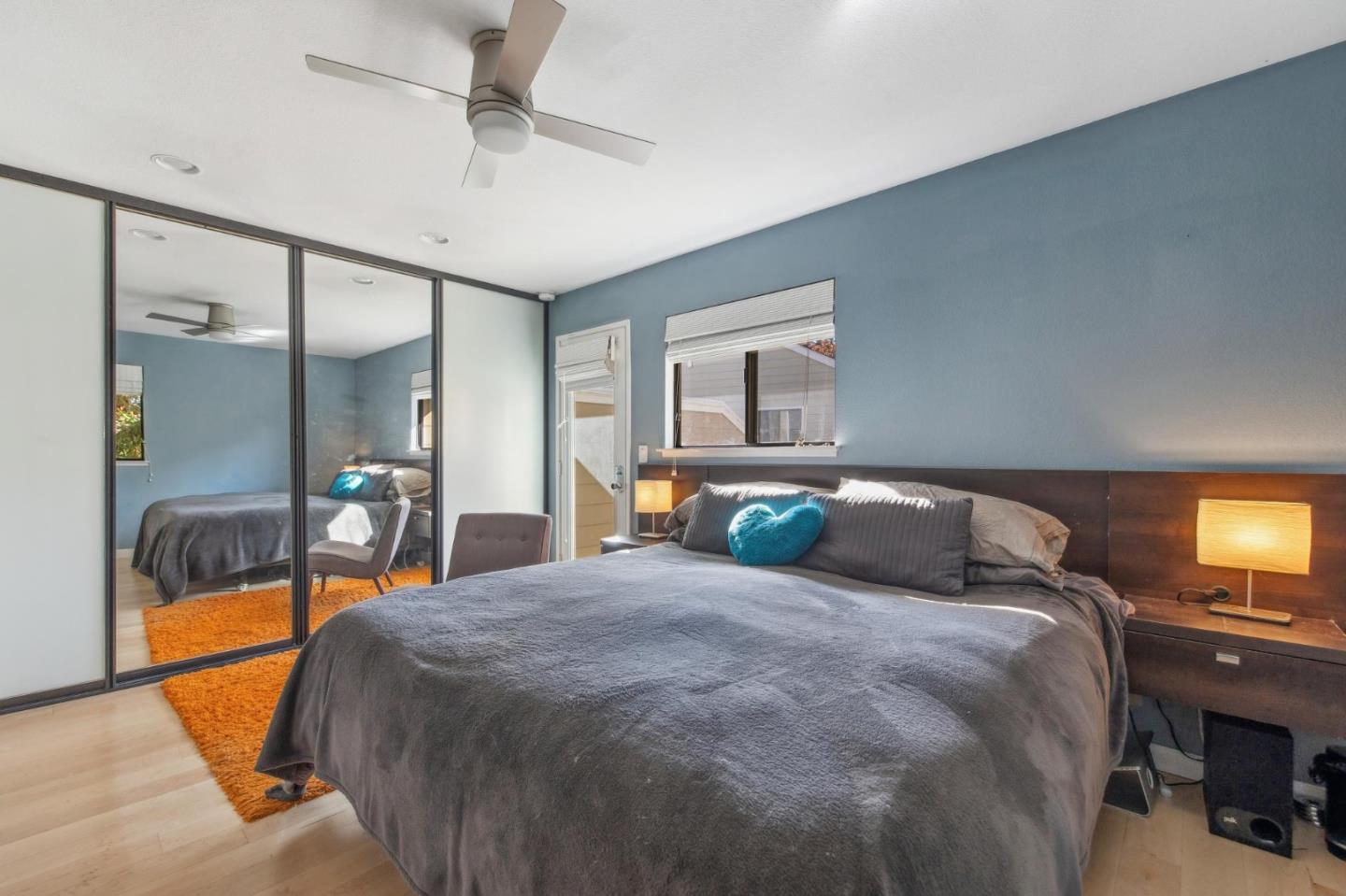 181 Ada Avenue, Unit 47 Mountain View, CA 94043 - Photo 13 of 32 a bedroom with a bed and a chandelier