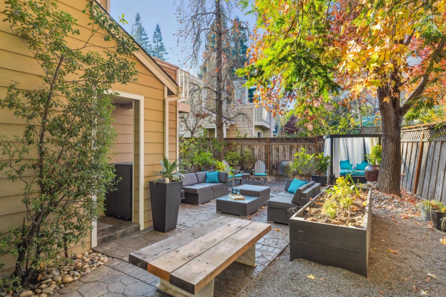 181 Ada Avenue, Unit 47 Mountain View, CA 94043 - Photo 24 of 32 a view of a patio with couches plants and large trees
