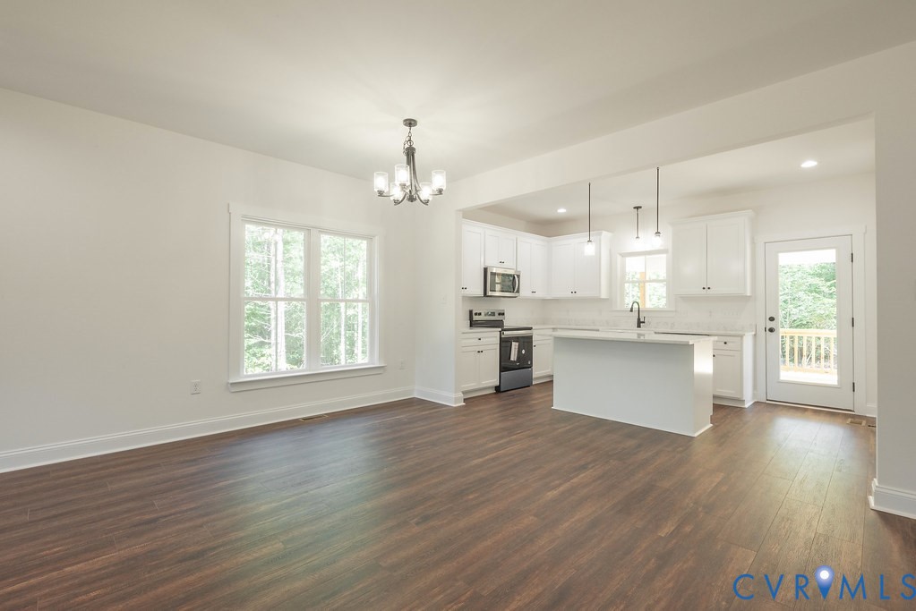 2355 Wickham Road Bumpass, VA 23024 - Photo 14 of 46 a view of large kitchen with wooden floor and stainless steel appliances