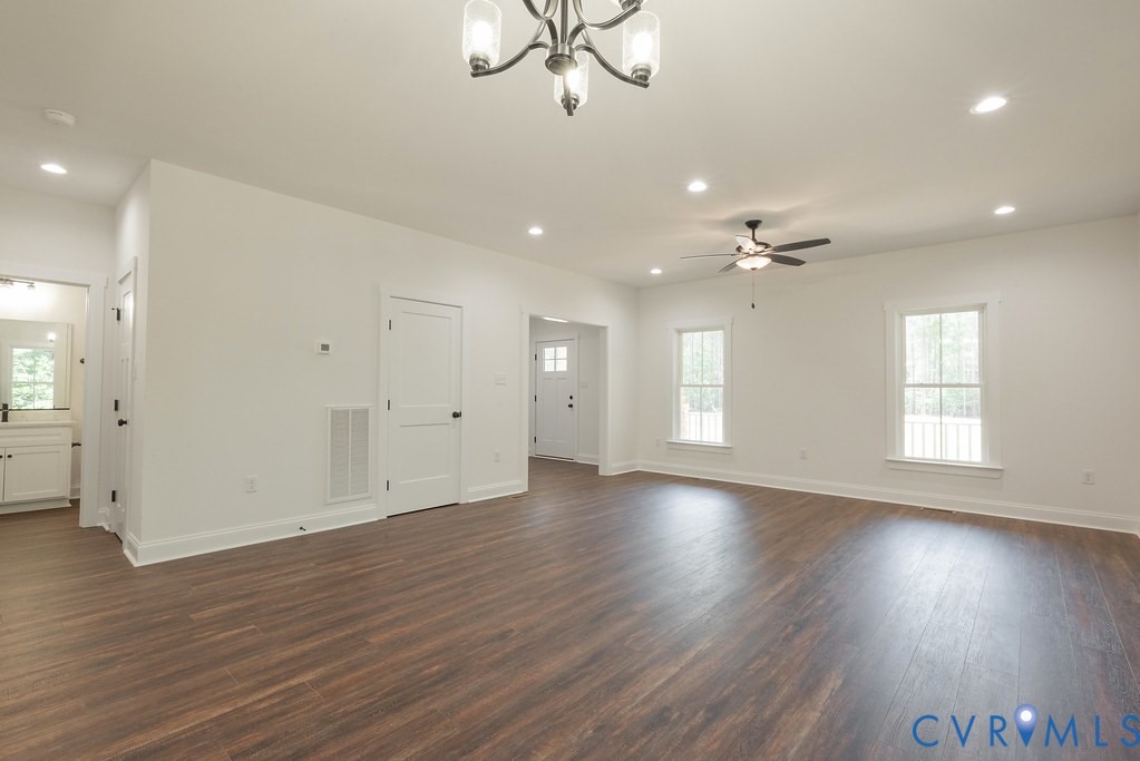 2355 Wickham Road Bumpass, VA 23024 - Photo 15 of 46 an empty room with wooden floor and windows