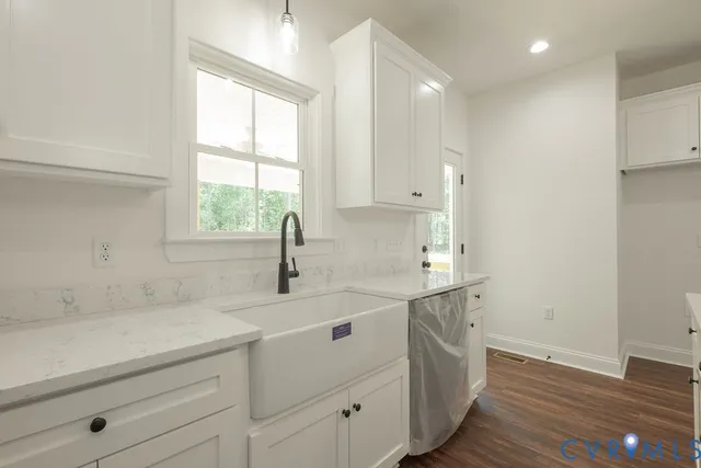 a kitchen with a sink cabinets appliances and a window