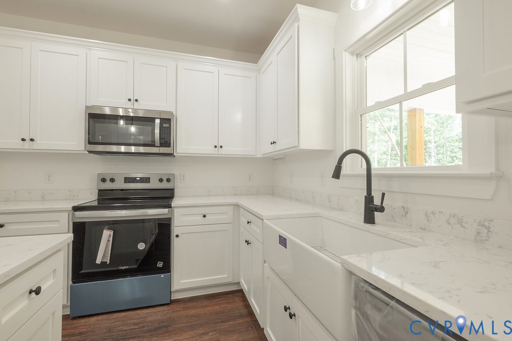 2355 Wickham Road Bumpass, VA 23024 - Photo 23 of 46 a kitchen with stainless steel appliances granite countertop a stove a sink and a microwave