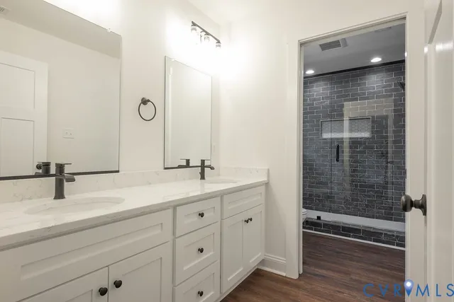 a bathroom with a double vanity sink and mirror
