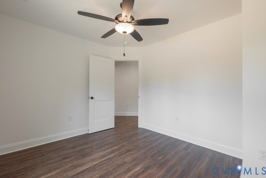 2355 Wickham Road Bumpass, VA 23024 - Photo 41 of 46 an empty room with wooden floor ceiling fan and window