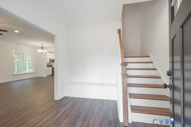 a view of an entryway with wooden floor and door