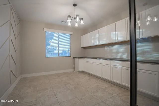 a large kitchen with a large counter top and stainless steel appliances