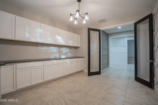 a large kitchen with a large counter top stainless steel appliances and cabinets