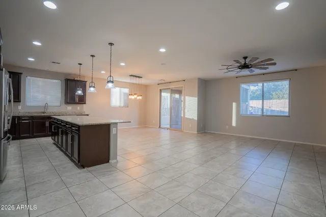 a view of a kitchen with a sink and chandelier