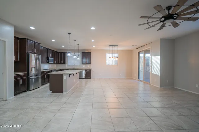 a large kitchen with a large counter top stainless steel appliances and cabinets