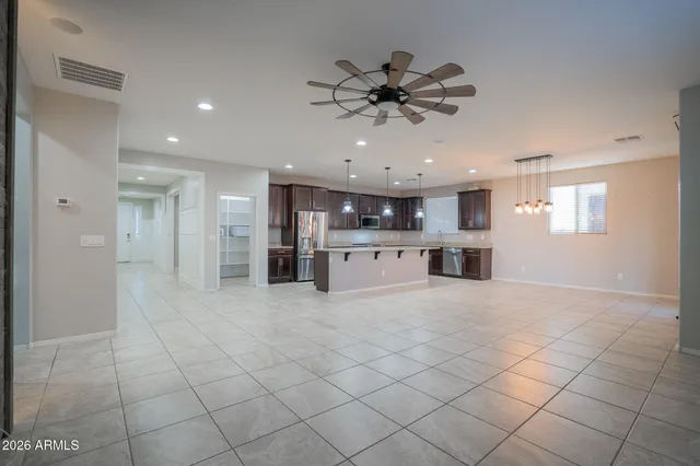 a large kitchen with stainless steel appliances granite countertop a stove and a wooden cabinets