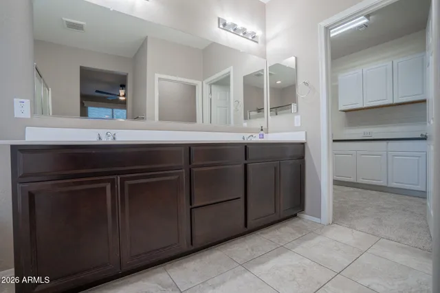 a kitchen with white cabinets and a wooden floors