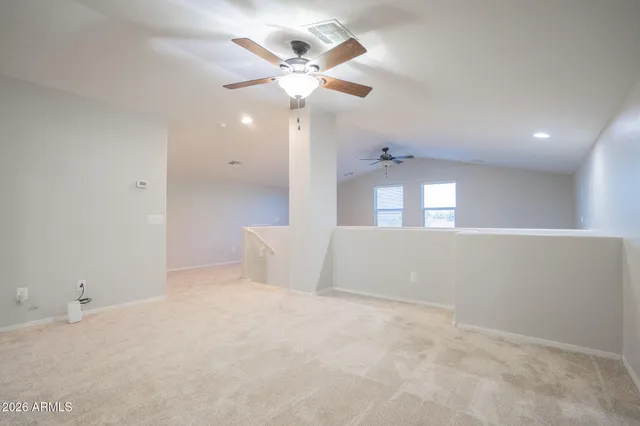 a view of an empty room with a ceiling fan