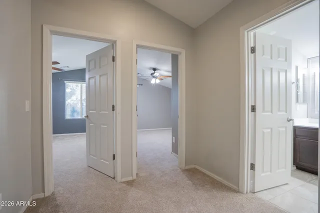 an empty room with a ceiling fan and a window