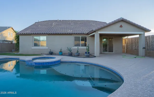 a view of a backyard with table and chairs and potted plants