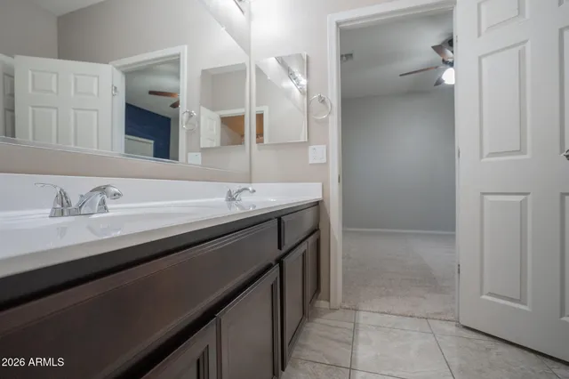 a bathroom with a double vanity sink a and mirror