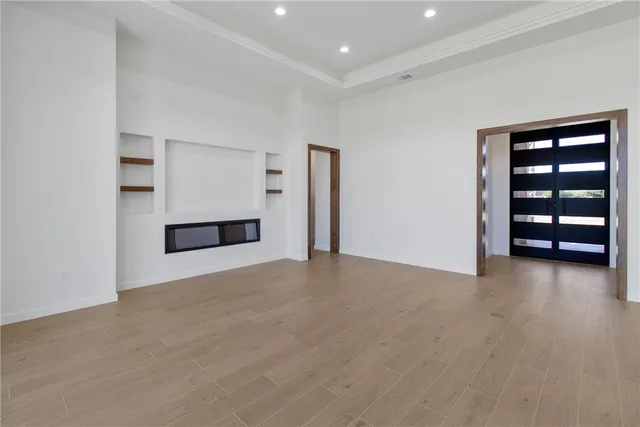 a view of empty room with wooden floor and closet