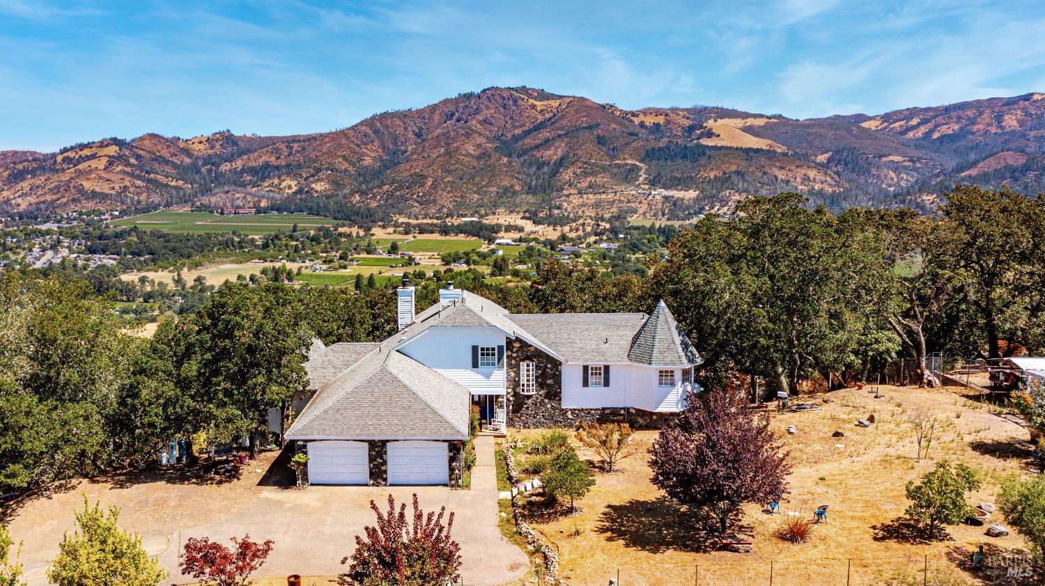 a view of a house with a mountain yard
