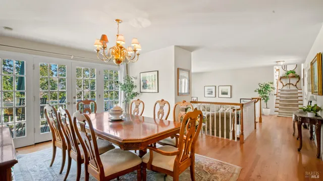 a view of a dining room with furniture wooden floor and chandelier