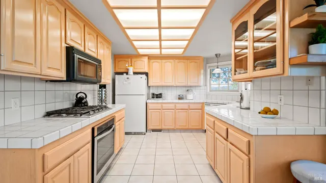a kitchen with a sink a stove and cabinets