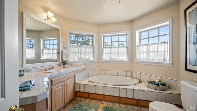 a bedroom with a bed and a chandelier fan