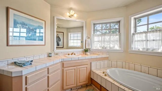 a view of a livingroom with workspace and a window