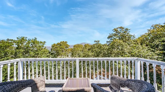 a view of a yard with wooden fence