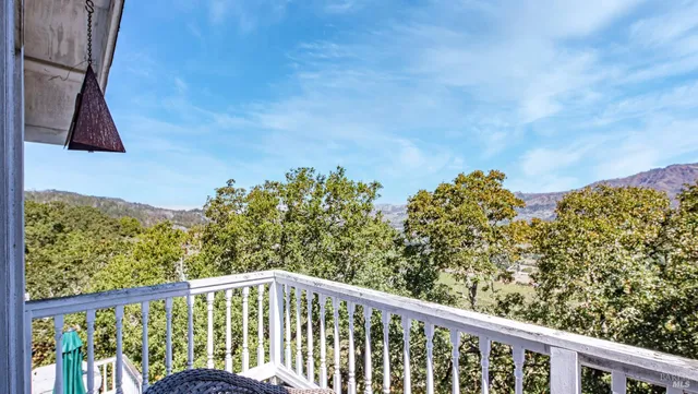 a balcony with view of outdoor space