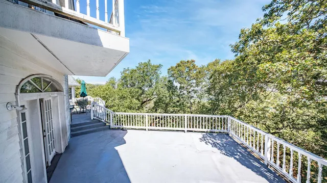 a view of a chairs and table in the balcony
