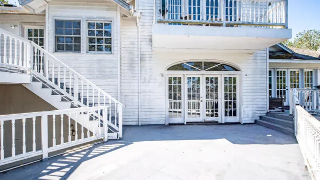 an aerial view of residential houses with outdoor space and river