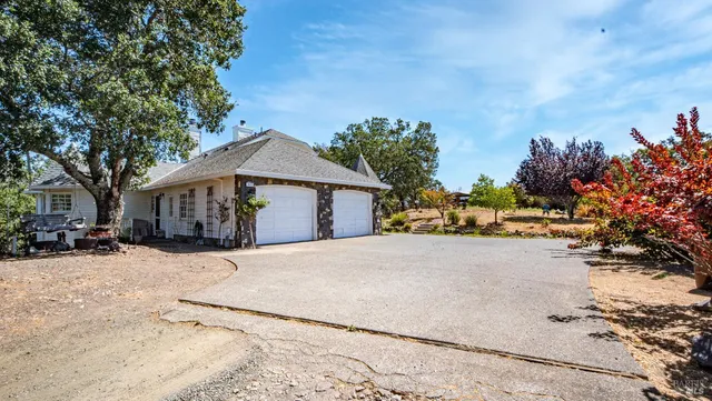 a front view of a house with a yard covered with snow