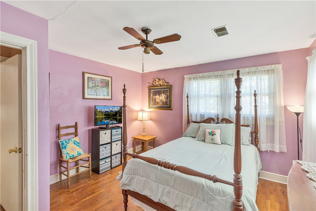 219 Beaty Square Anderson, SC 29624 - Photo 17 of 32 This cozy bedroom features hardwood floors and a ceiling fan for optimal comfort.