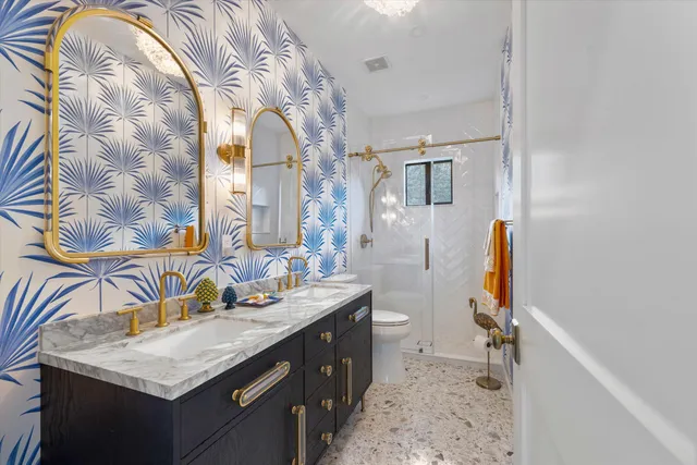 a bathroom with a sink toilet and shower