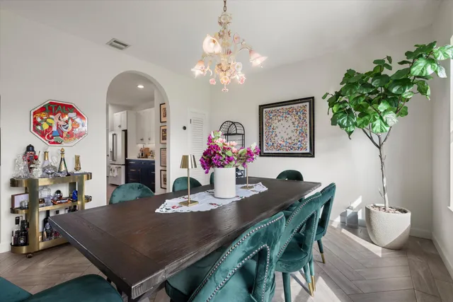 a kitchen with stainless steel appliances granite countertop a refrigerator sink and white cabinets